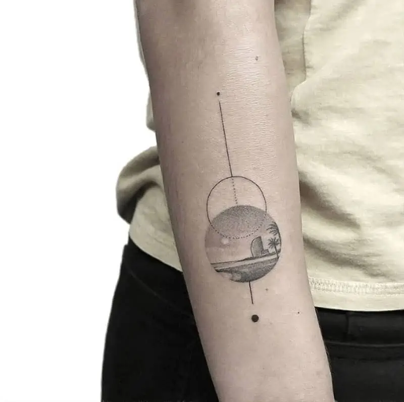 Landscape circle tattoo on the right inner forearm.