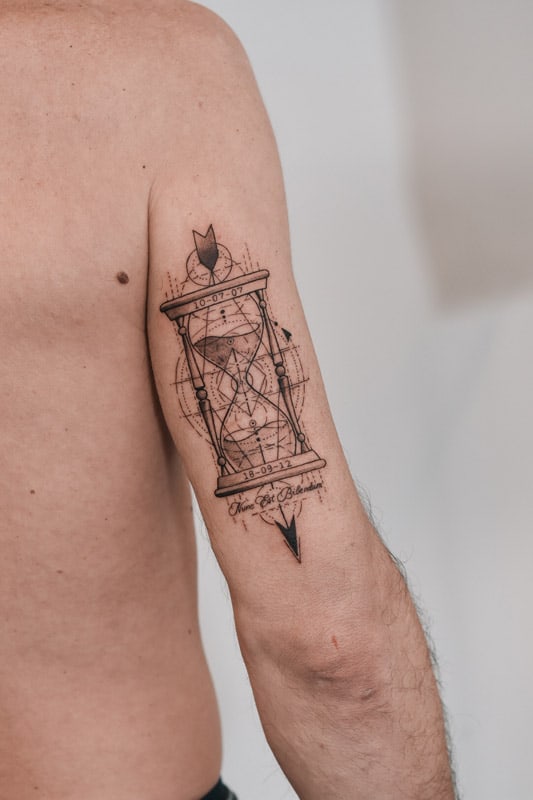 hour glass on triceps geometric tattoo