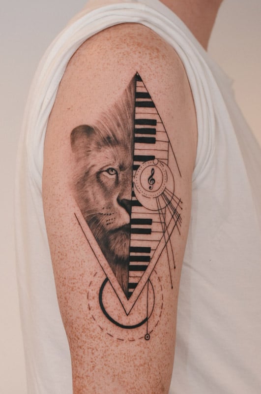 lion and keyboard arm geometric tattoo