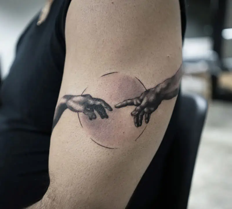 2 hands tattoo on arm tattoo