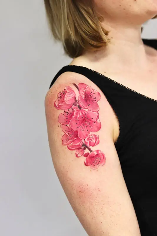 pink flowers tattoo on arm realistic