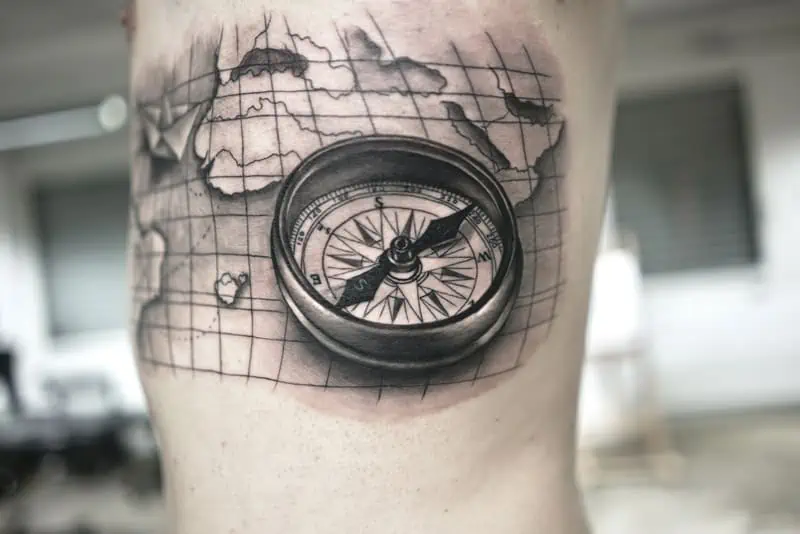 compass with map tattoo on side chest